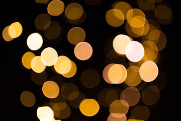 Image showing blurred golden lights over dark background