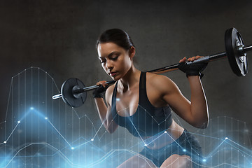 Image showing young woman flexing muscles with barbell in gym