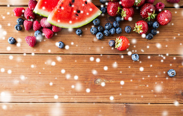 Image showing close up of fruits and berries on wooden table