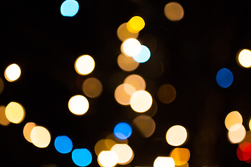 Image showing blurred golden lights over dark background