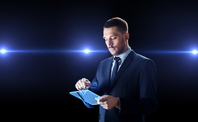 Image showing businessman in suit with transparent tablet pc