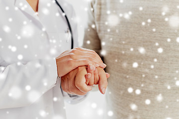 Image showing close up of doctor holding old man hand