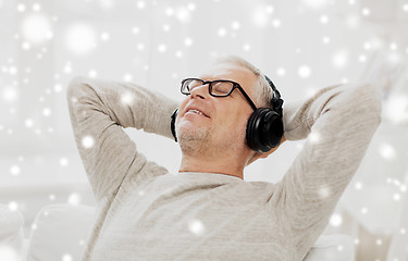 Image showing happy man in headphones listening to music