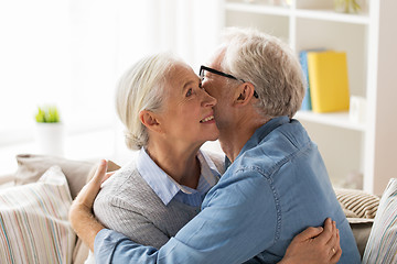 Image showing happy senior couple hugging at home