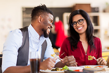 Image showing happy couple eating at restaurant