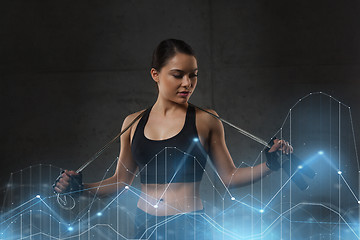 Image showing young sporty woman with jumping rope