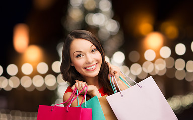 Image showing smiling woman with colorful shopping bags