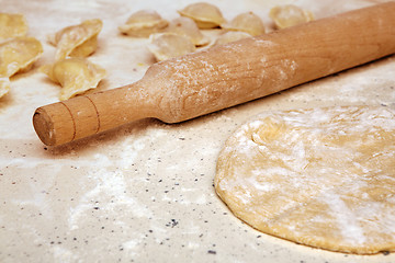 Image showing rolling pin and dough on table
