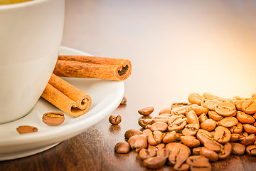 Image showing Macro shot with white cup of coffee and cinnamon