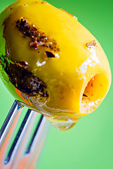 Image showing Closeup grilled olive on the fork