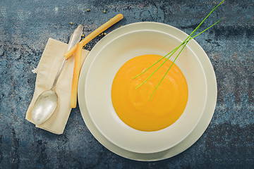 Image showing Delicious healthy pumpkin soup, spoon and napkin