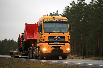 Image showing Yellow MAN Truck Hauls Sandvik Machinery