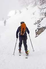 Image showing Man with skis walk by snow on the mountain