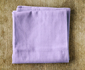 Image showing violet towel on wooden table
