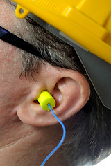 Image showing man with protective ear plugs