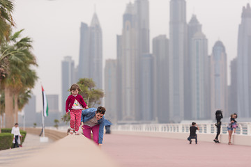 Image showing mother and cute little girl on the promenade