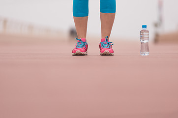 Image showing close up on running shoes and bottle of water