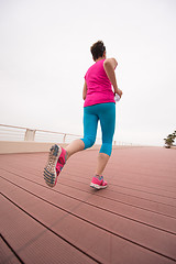 Image showing woman busy running on the promenade