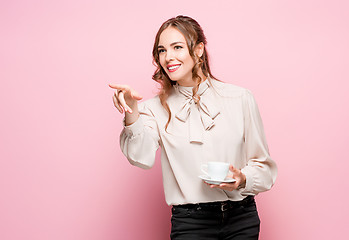 Image showing The serious frustrated young beautiful business woman on pink background