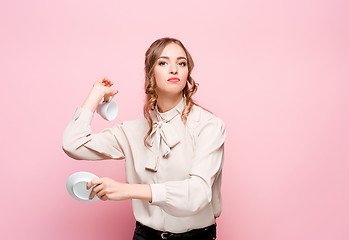 Image showing The serious frustrated young beautiful business woman on pink background