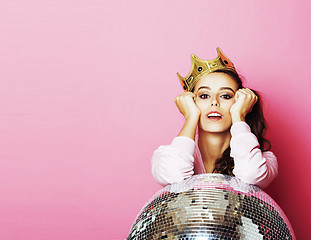 Image showing young cute disco girl on pink background with disco ball and cro