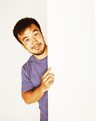 Image showing pretty cool asian man holding empty white plate smiling