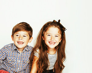 Image showing little cute boy and girl hugging playing on white background, ha