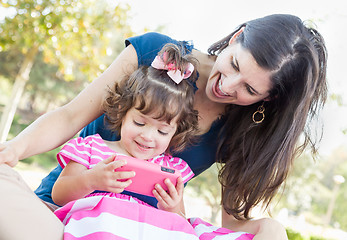 Image showing Mixed Race Mother and Cute Baby Daughter Playing with Cell Phone