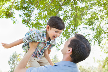 Image showing Happy Caucasian Father and Son Playing Together in the Park.