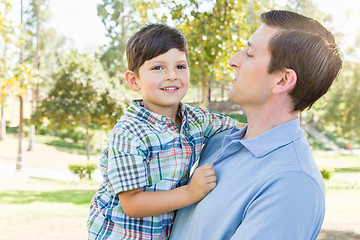 Image showing Happy Caucasian Father and Son Playing Together in the Park.