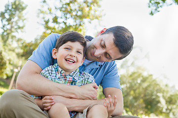 Image showing Loving Young Father Tickling Son in the Park.
