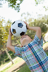 Image showing Cute Young Boy Playing with Soccer Ball Outdoors in the Park.