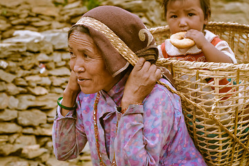 Image showing Woman with child in basket in Nepal