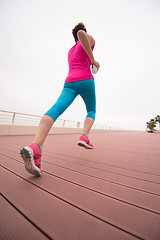 Image showing woman busy running on the promenade