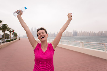 Image showing young woman celebrating a successful training run