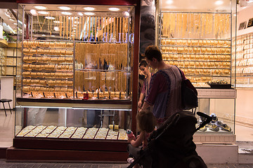 Image showing mother with  little girl in a stroller in front of  jewelry shop