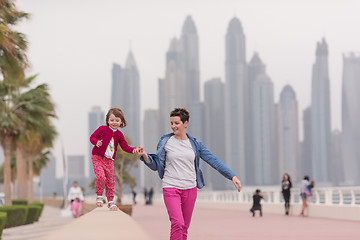 Image showing mother and cute little girl on the promenade