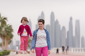 Image showing mother and cute little girl on the promenade