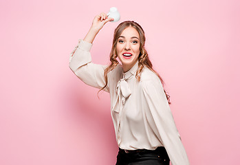 Image showing The serious frustrated young beautiful business woman on pink background