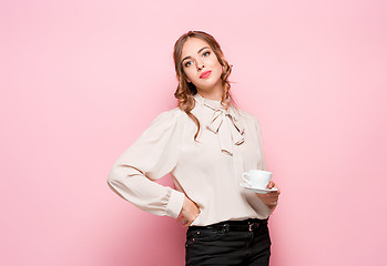 Image showing The serious frustrated young beautiful business woman on pink background