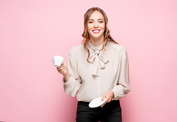 Image showing The serious frustrated young beautiful business woman on pink background