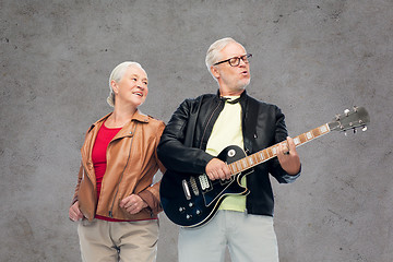 Image showing happy senior couple with electric guitar