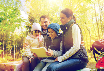 Image showing happy family with tablet pc and backpacks at camp