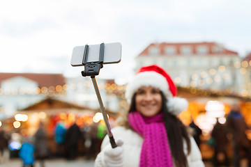 Image showing woman taking selfie with smartphone at christmas 