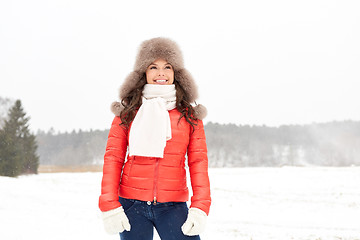 Image showing happy woman in winter fur hat outdoors