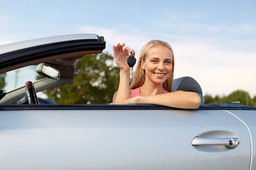 Image showing happy young woman with convertible car key