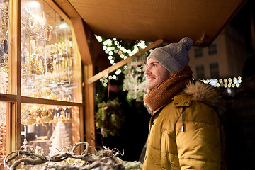 Image showing happy man looking at christmas market shop window