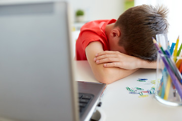 Image showing tired or sad student boy with laptop at home