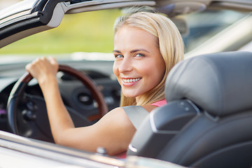 Image showing happy young woman driving convertible car