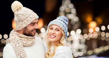 Image showing happy couple hugging over christmas lights